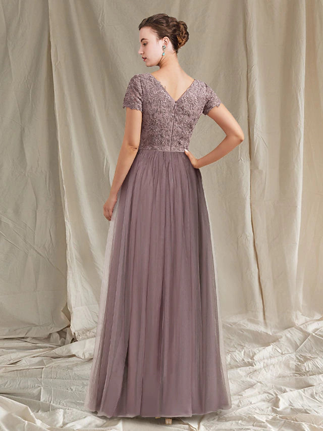 Floor-length lace and tulle gown with appliques and pleats.
