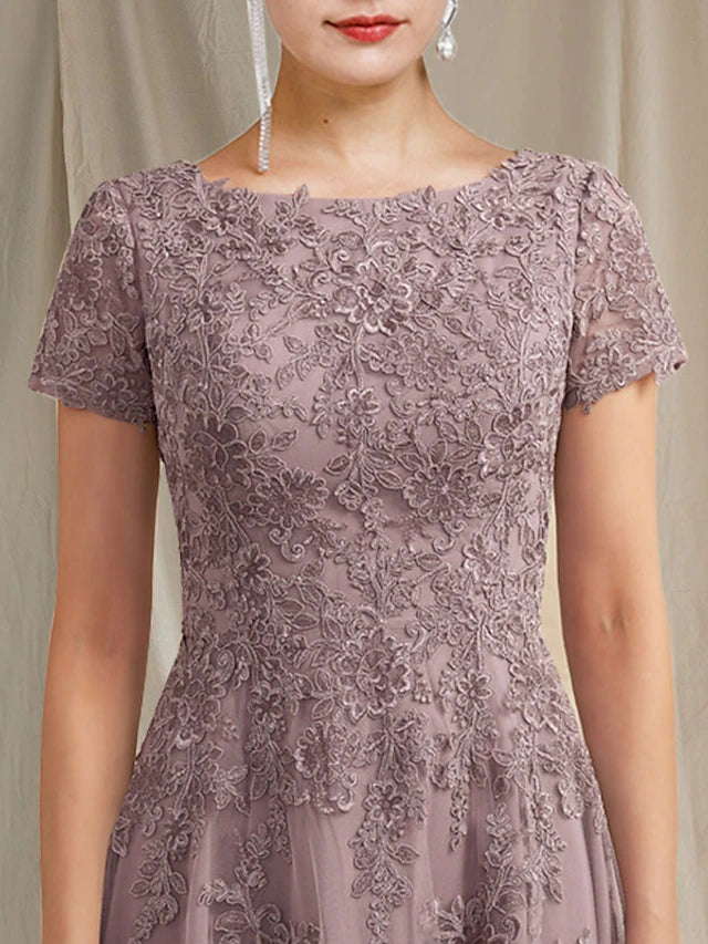 Detail of lace and tulle fabric with appliques on a formal tea-length dress.