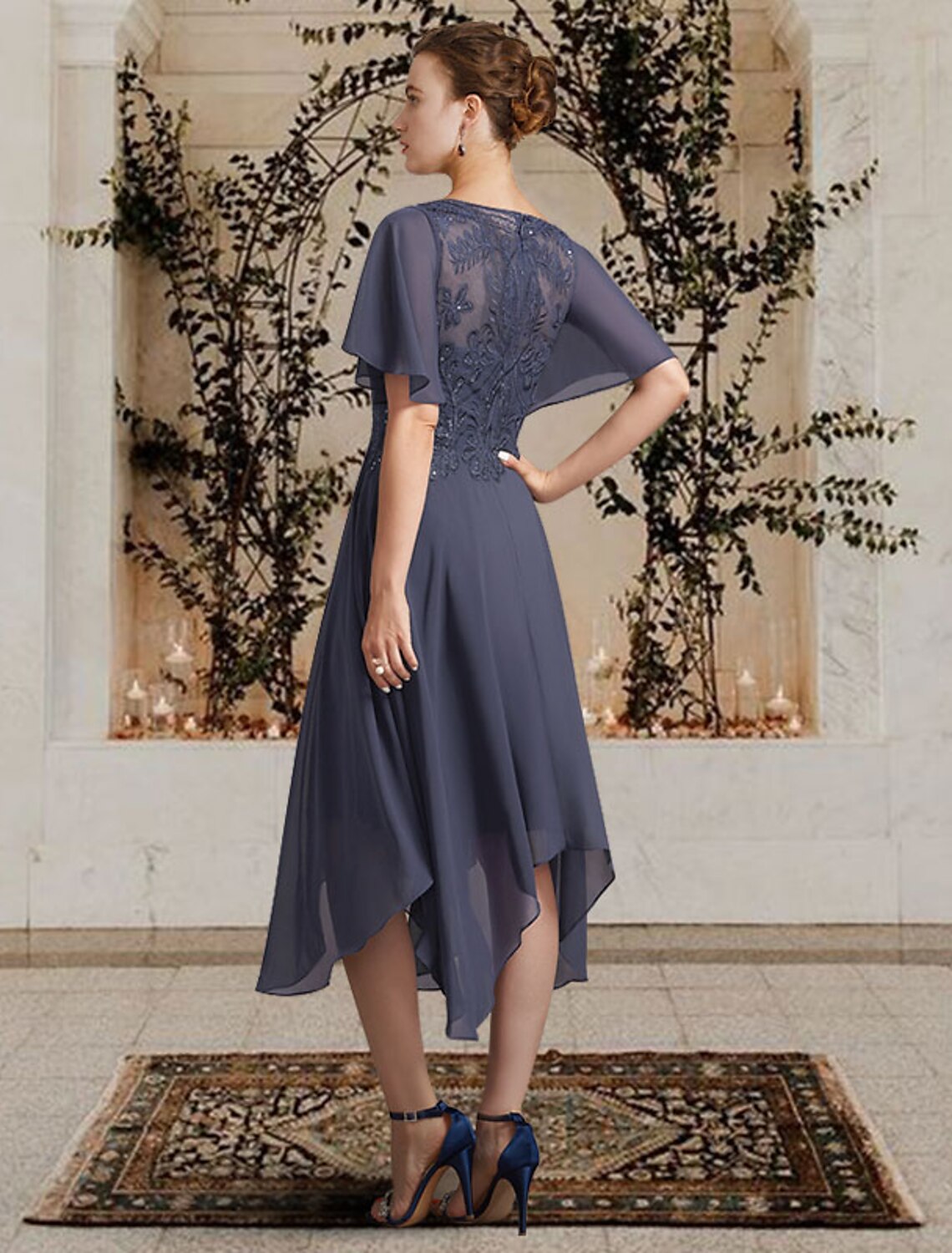 Side view of the Mother of the Bride dress, showcasing the asymmetrical hem and lace details.