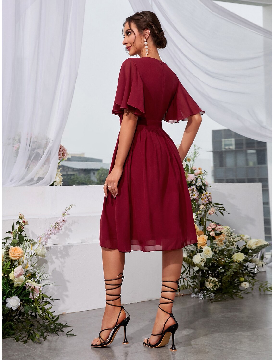 Model wearing A-Line jewel neck dress for holiday occasion.