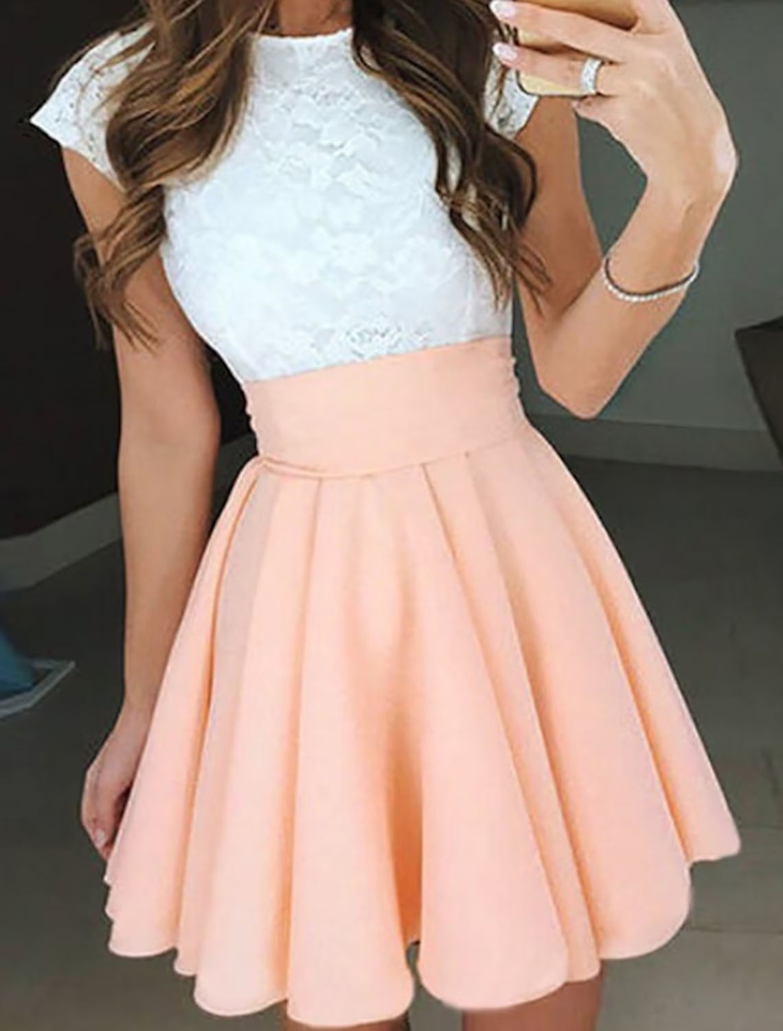 Back view of an A-line jewel neck short sleeve pleated mini cocktail dress.