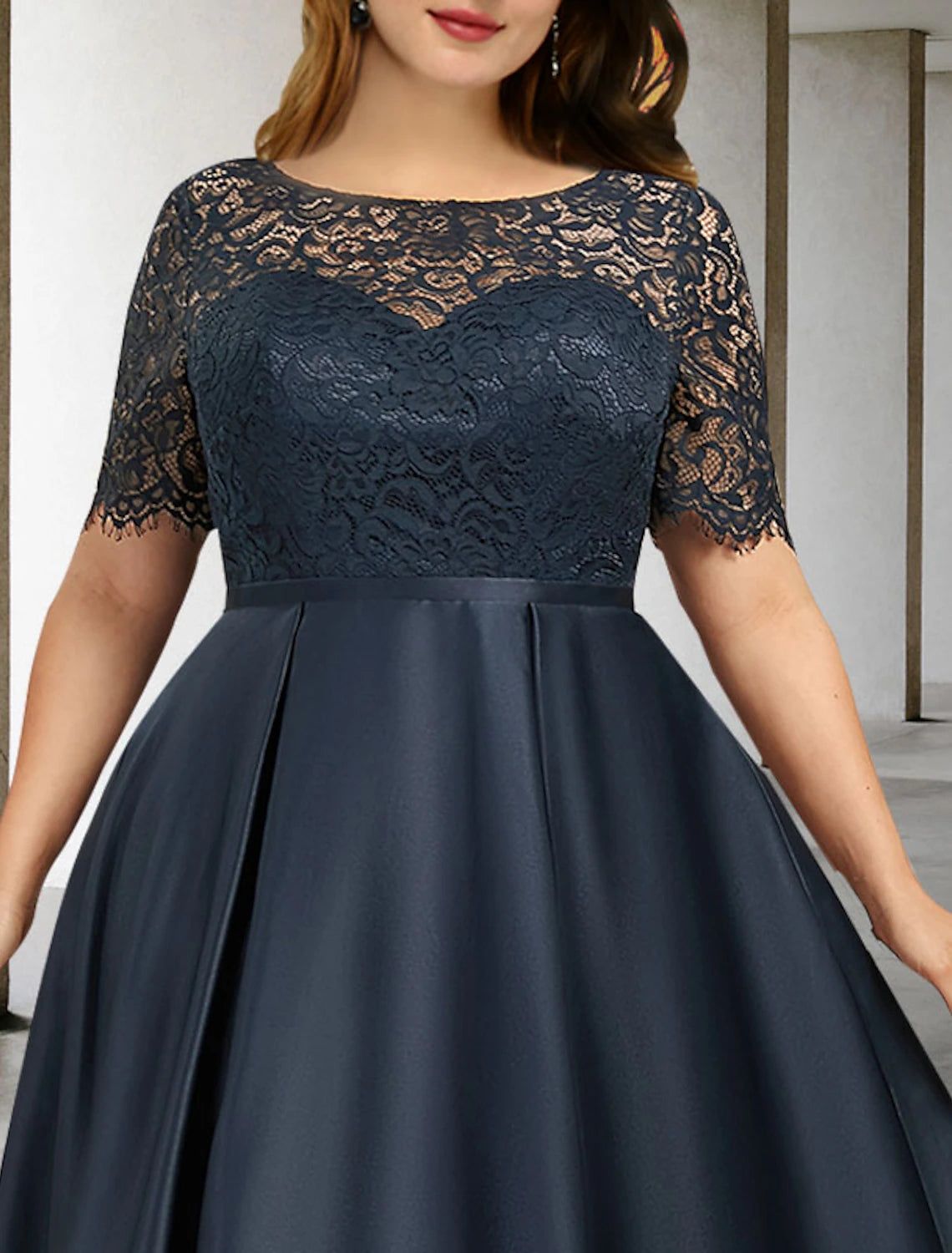Side view of the elegant A-line plus size Mother of the Bride dress, showing the satin fabric and pleats.