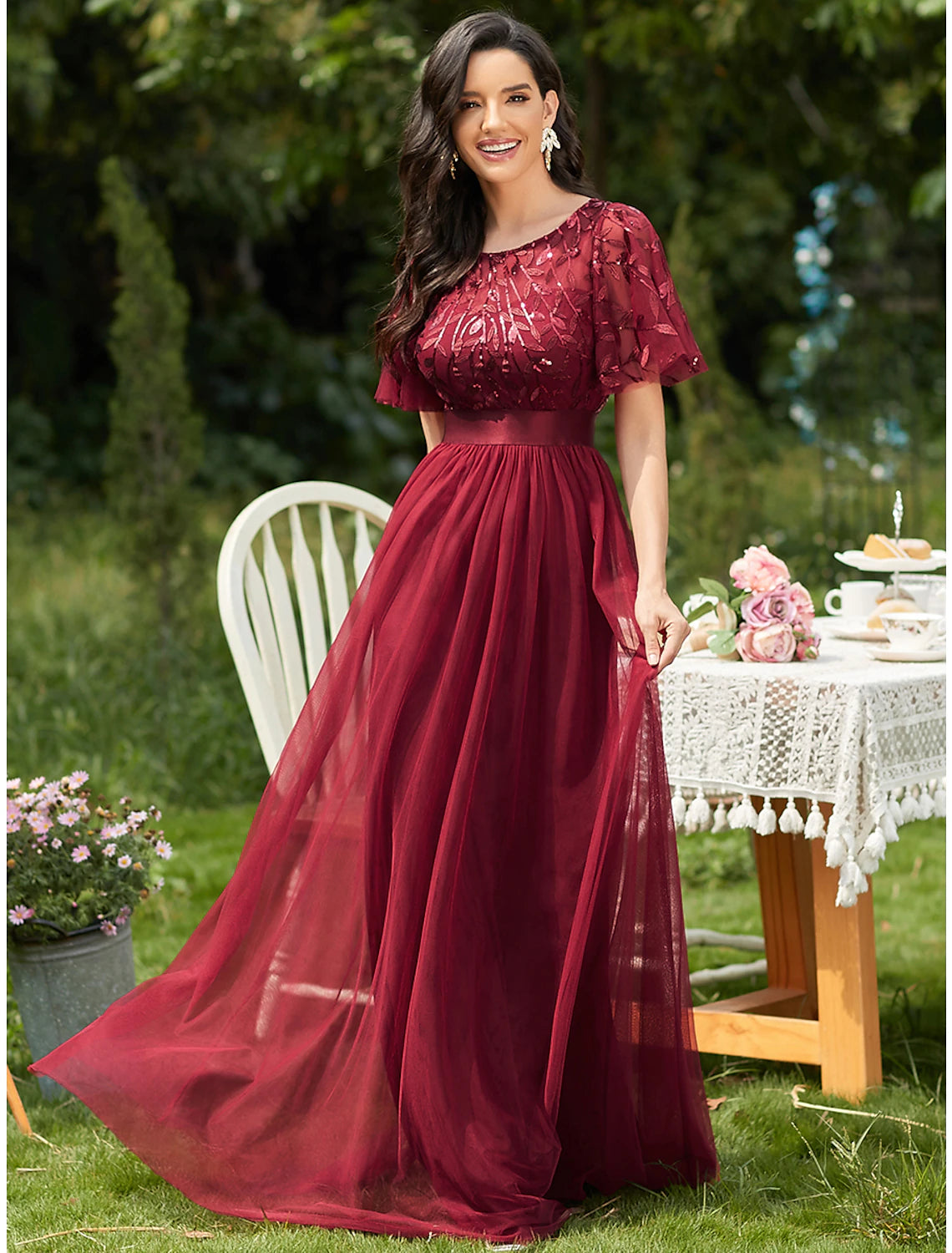 A-line prom dress with jewel neck, short sleeves, and sequin appliques.