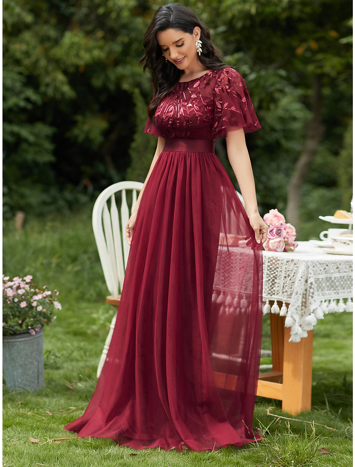 Back view of a floor-length tulle prom dress with ruffles.