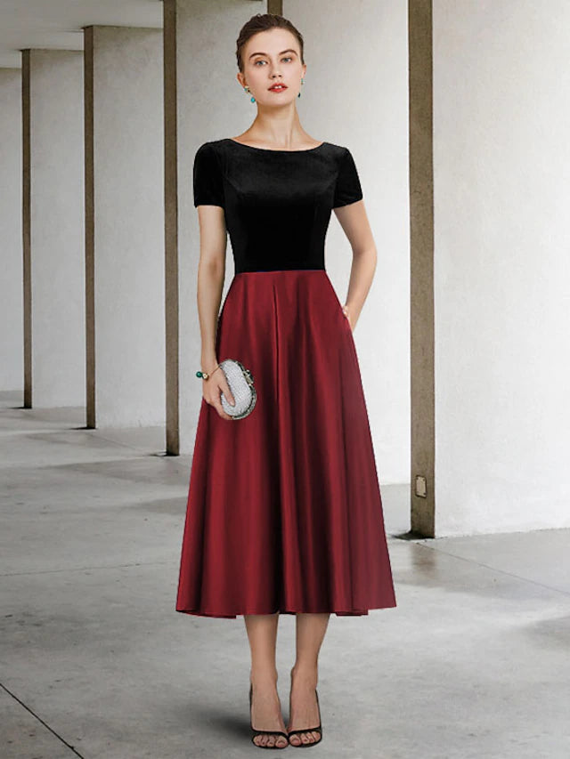Elegant A-Line Mother of the Bride dress with jewel neck and short sleeves, tea length.