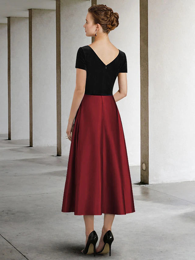Back view of A-Line Mother of the Bride dress, showing pleated skirt and color block detail.