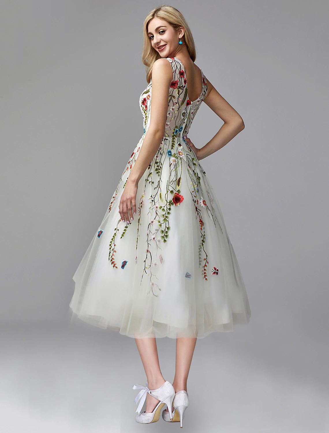 Sleeveless tea-length chiffon dress with intricate floral lace details.