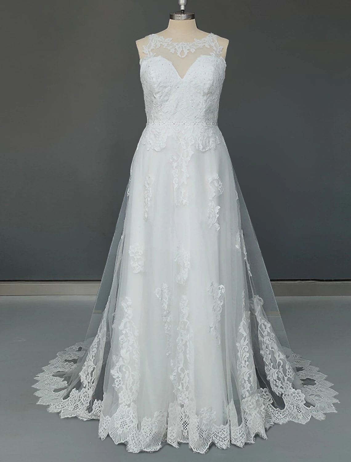 Plus size A-line wedding dress with jewel neck and lace appliques.