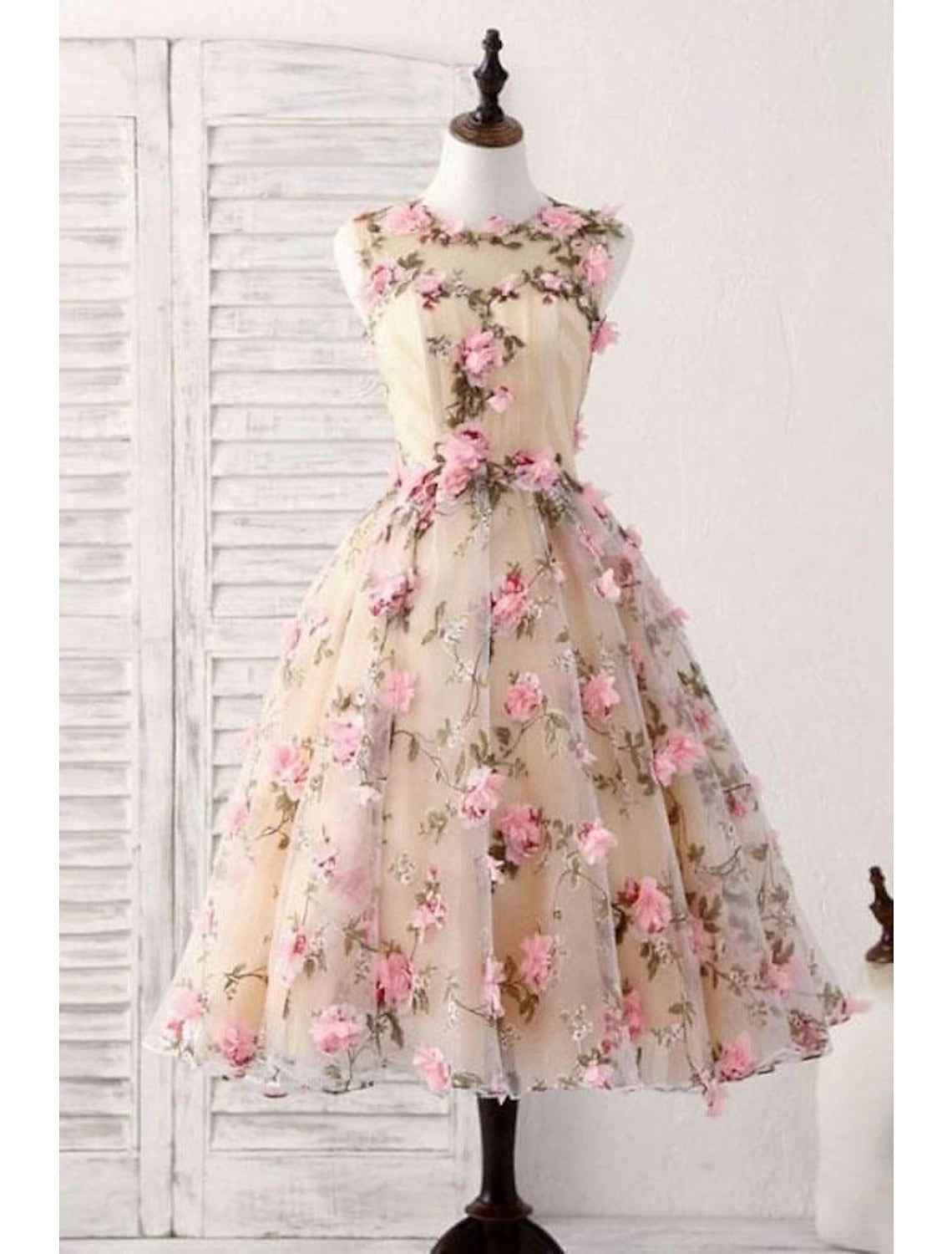 Elegant A-Line satin cocktail dress with jewel neck and appliques.