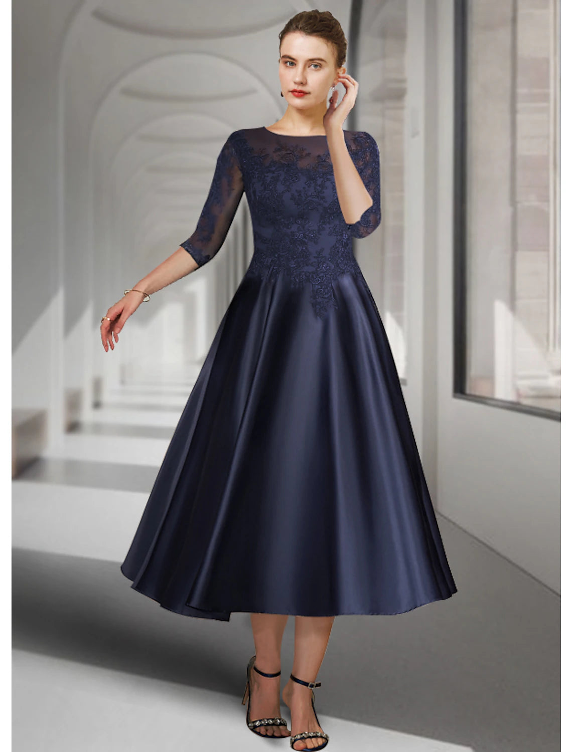 Elegant A-line mother of the bride dress in dark blue satin lace with 3/4 sleeves.