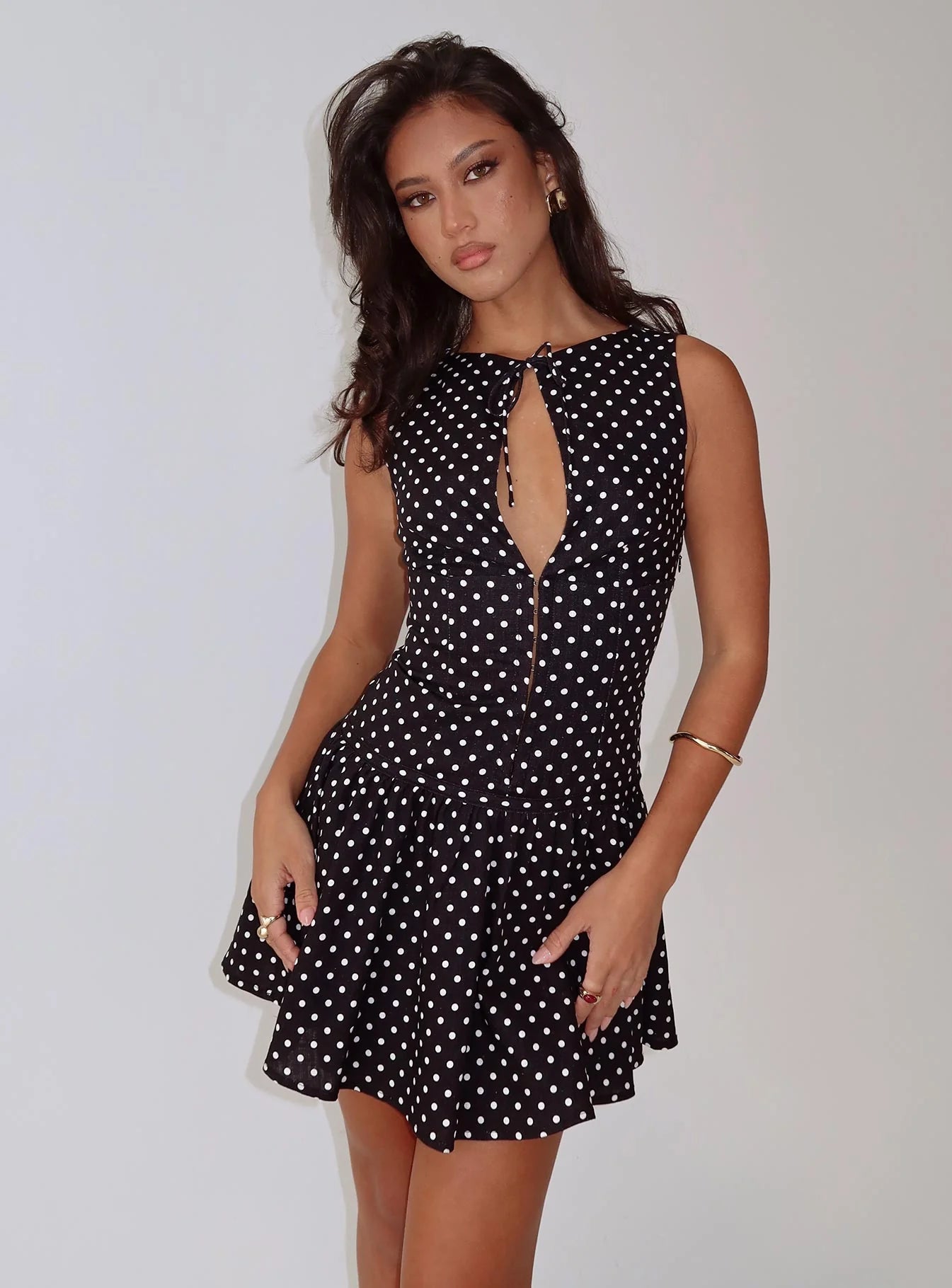 Elegant black and white polka dot mini dress with keyhole tie front.