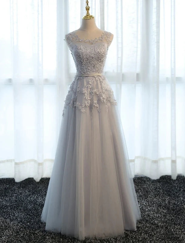 Full length view of a flowing tulle A-line dress with lace embellishments.