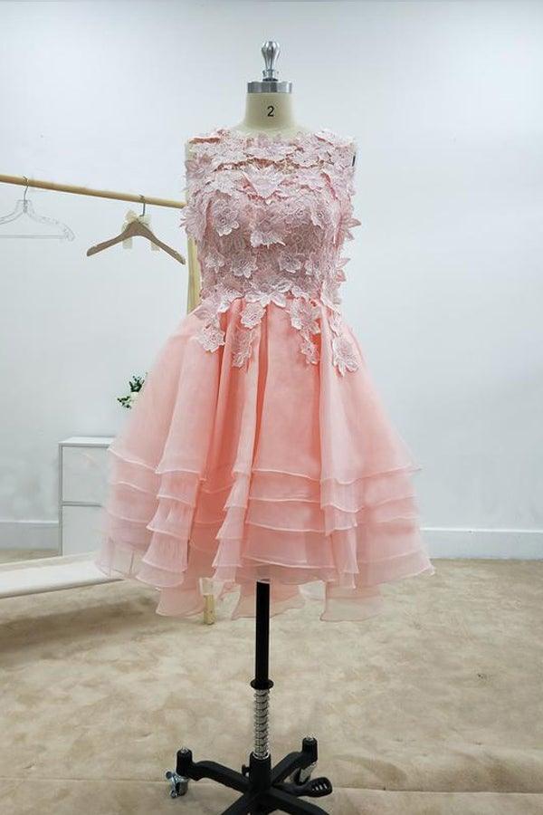 Close-up of lace and applique details on a pink homecoming dress.