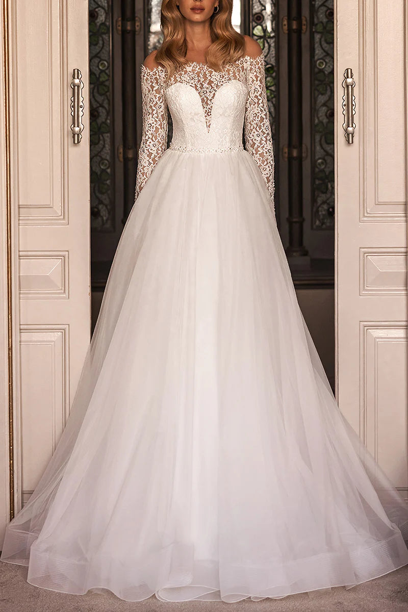 Close-up of the delicate lace detail and plunge neckline on the wedding dress.