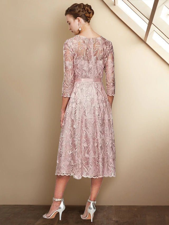 Side view of the tea-length charmeuse dress with delicate lace.
