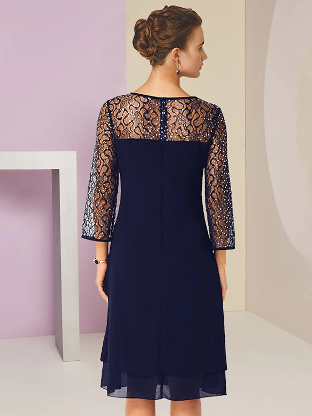 Close-up of the lace and sequin embellishments on the formal knee-length dress.