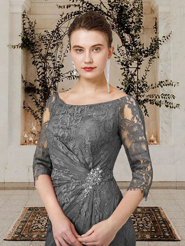 Close-up of the lace short sleeve and crystal brooch on a Mother of the Bride dress.