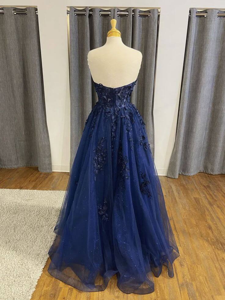 Full view of a navy blue A-line lace long evening dress.