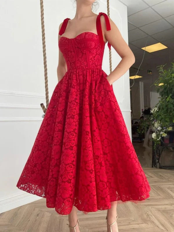 Elegant A-line lace tea length prom dress with pockets, front view.