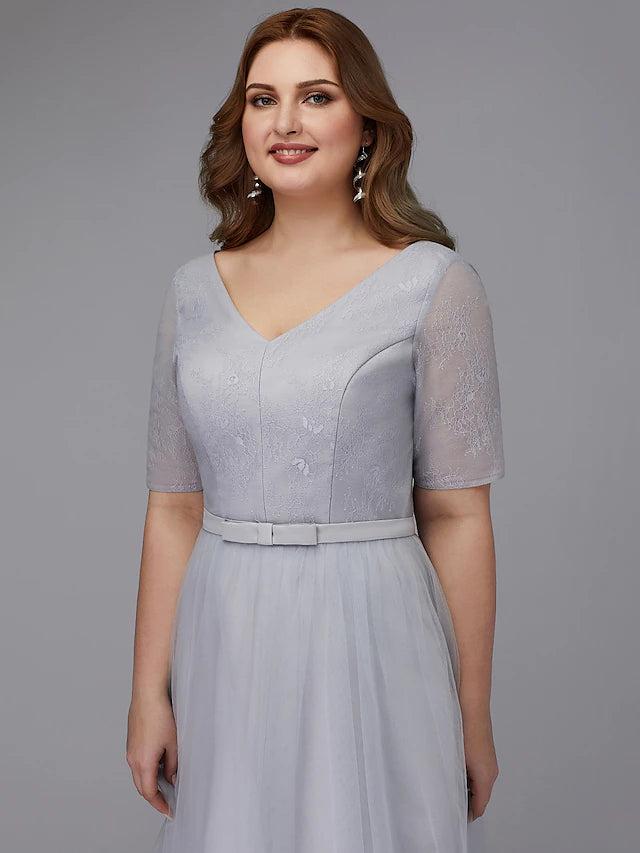 Close-up of lace V-neckline and short sleeve on dress.