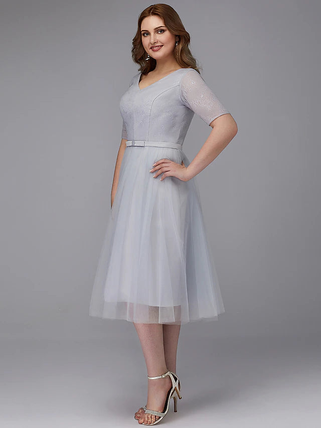 Side view of A-line tea length dress.