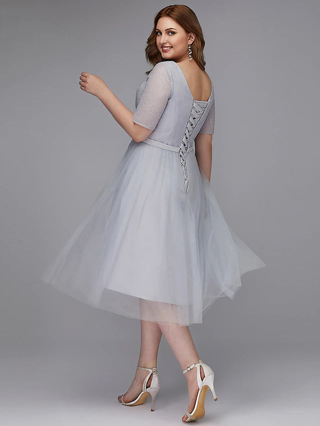 Detail of sash or ribbon on the A-line lace dress.