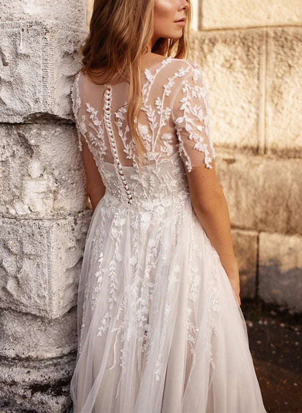 Close-up of the lace V-neck and short sleeves on an A-line wedding dress.