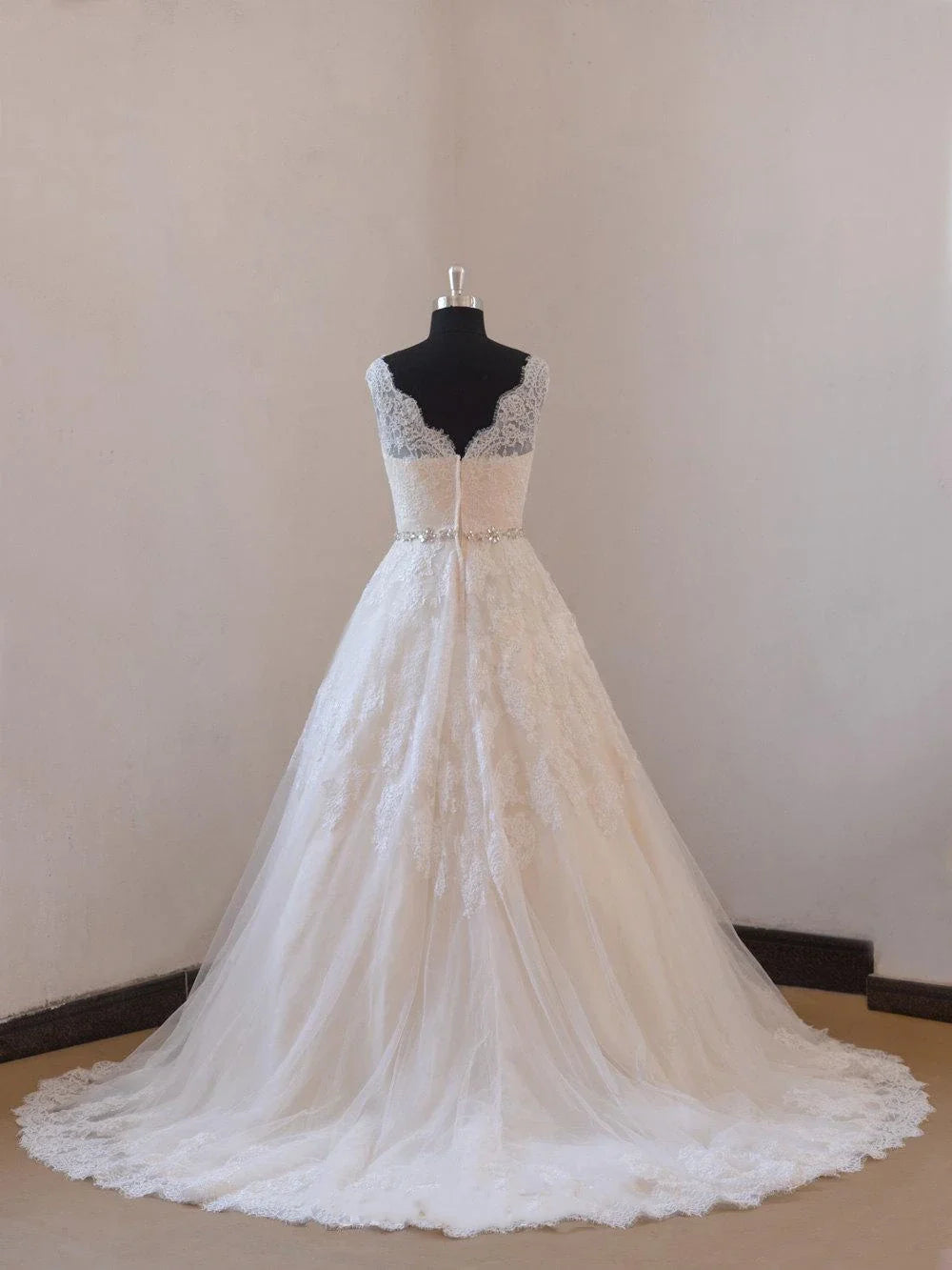 Close-up of the illusion neckline and intricate lace details on the wedding dress.