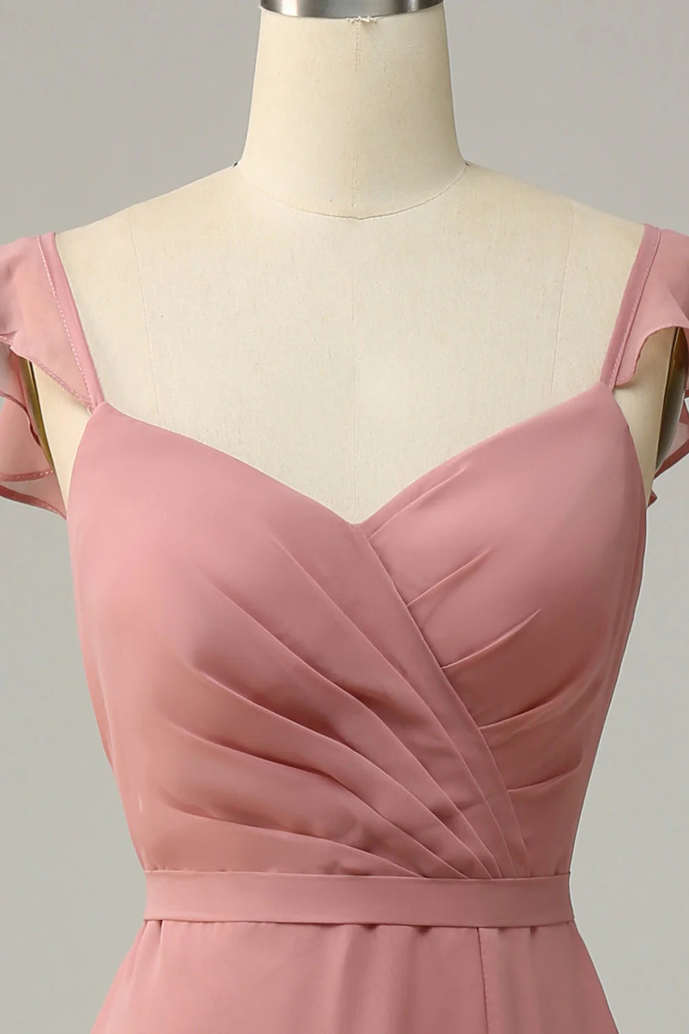 Full length view of a woman in a dusty rose A-line long bridesmaid dress.