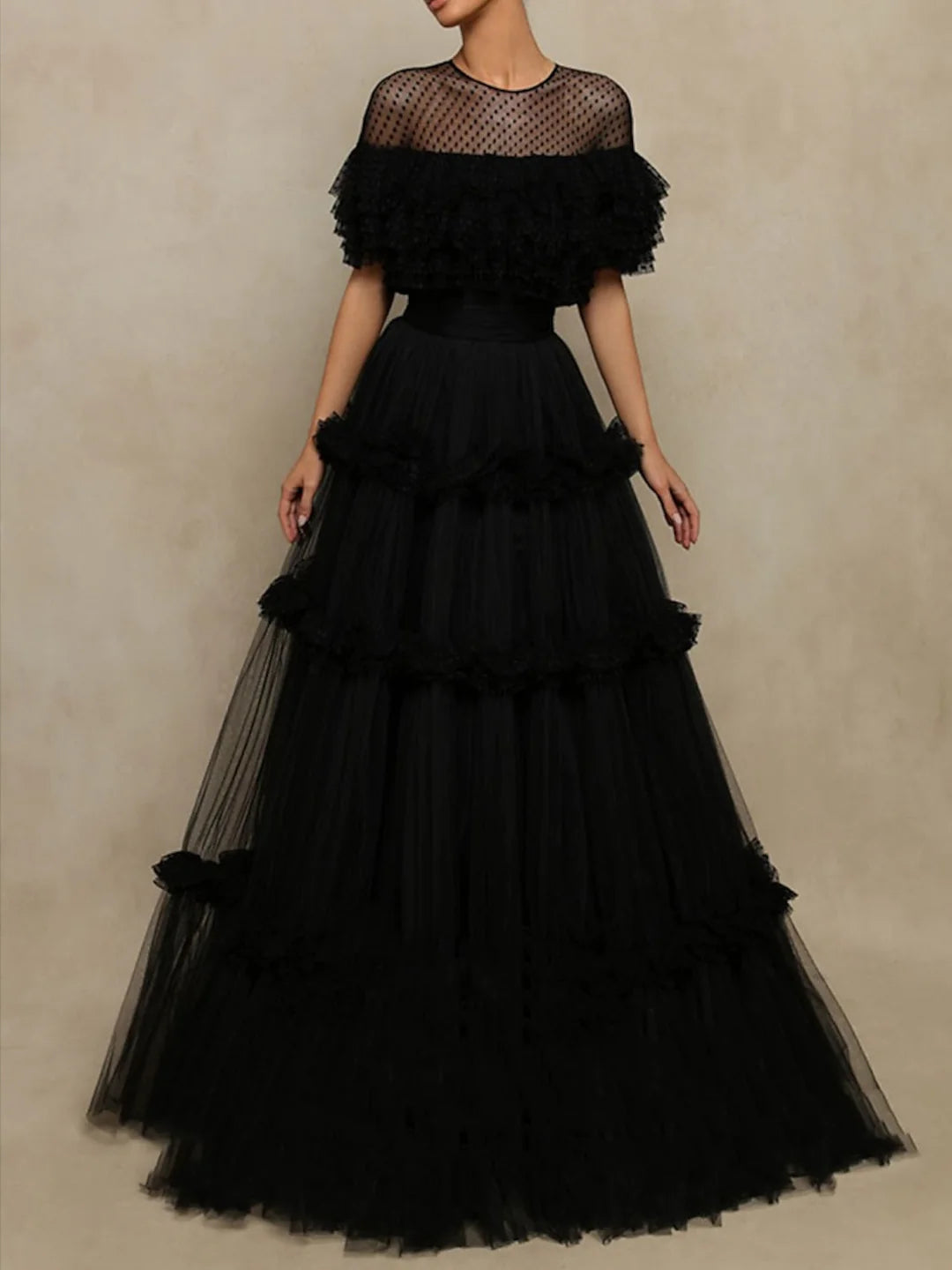 Woman wearing an elegant A-line long dress with long sleeves, suitable for formal events.