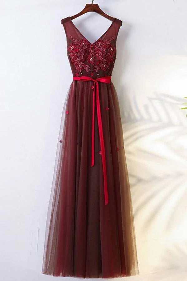 Elegant A-line long sleeve prom dress with appliques and a tulle belt.
