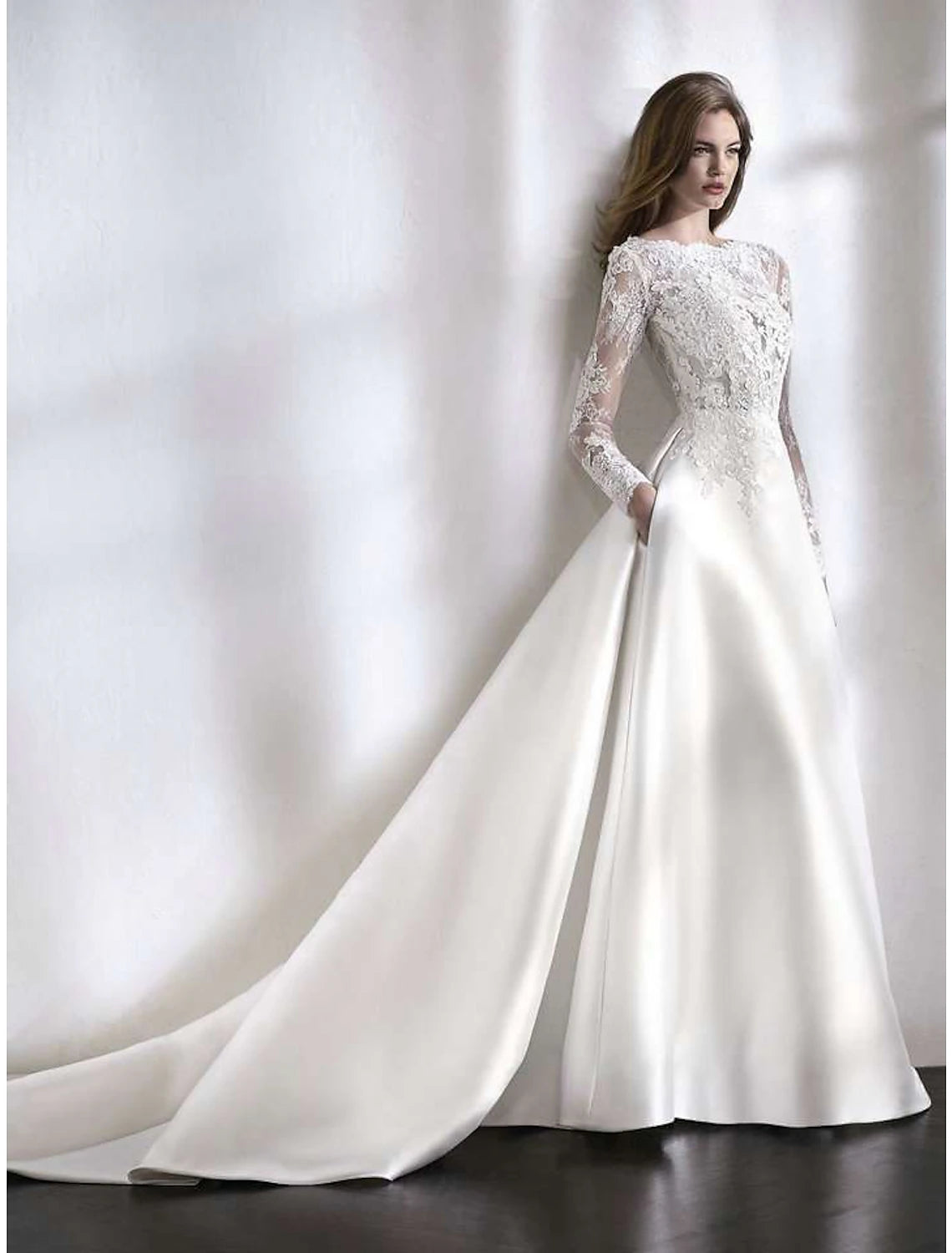 Elegant A-line long sleeve wedding dress with illusion neckline and chapel train.