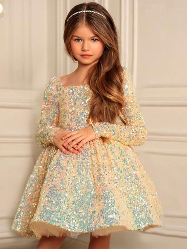 Little girl wearing a yellow A-line satin dress with sequins and ruched details.