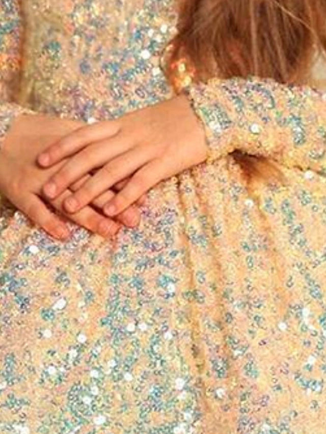Close-up of the sequin and ruched detailing on the satin dress.