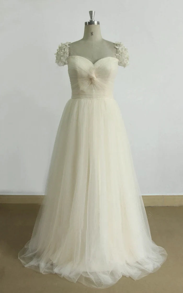 Elegant A-line wedding dress with long tulle sleeves and lace appliqué details.