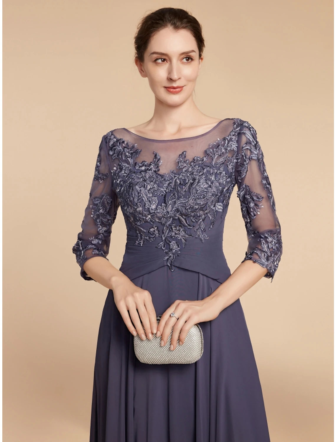 Close-up of the delicate lace detail on the bodice and sleeves of the formal gown.