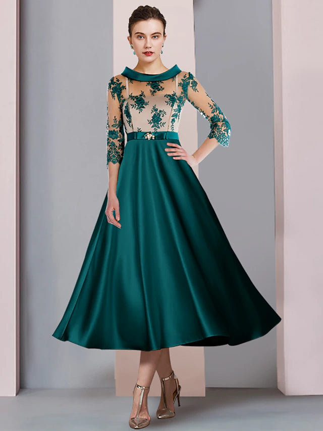Elegant A-line mother of the bride dress with scoop neck, 3/4 sleeves, tea length, appliques, and a crystal brooch.