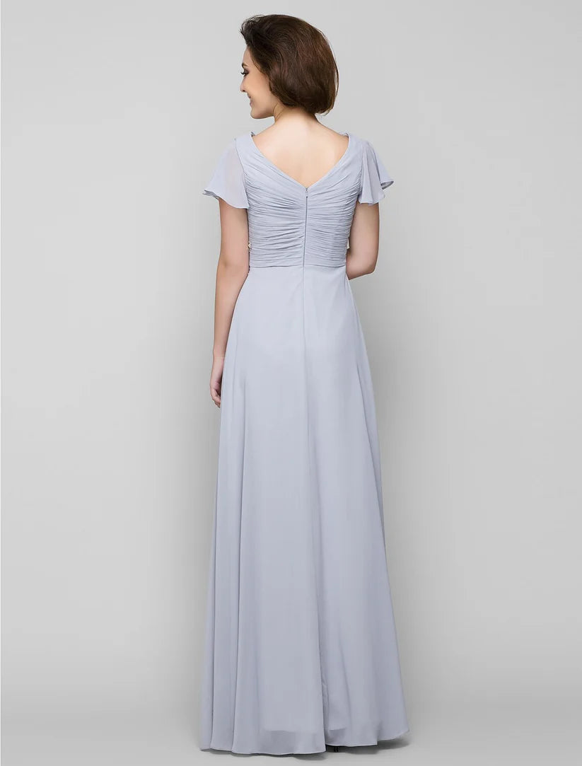 Elegant A-line Mother of the Bride dress with V-neck, chiffon fabric, and criss-cross crystal details.