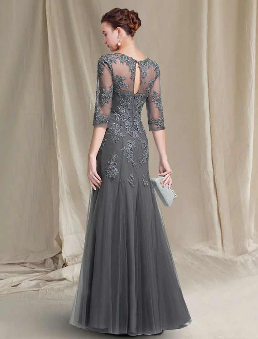 Side view of a woman wearing an A-Line lace and tulle formal gown.