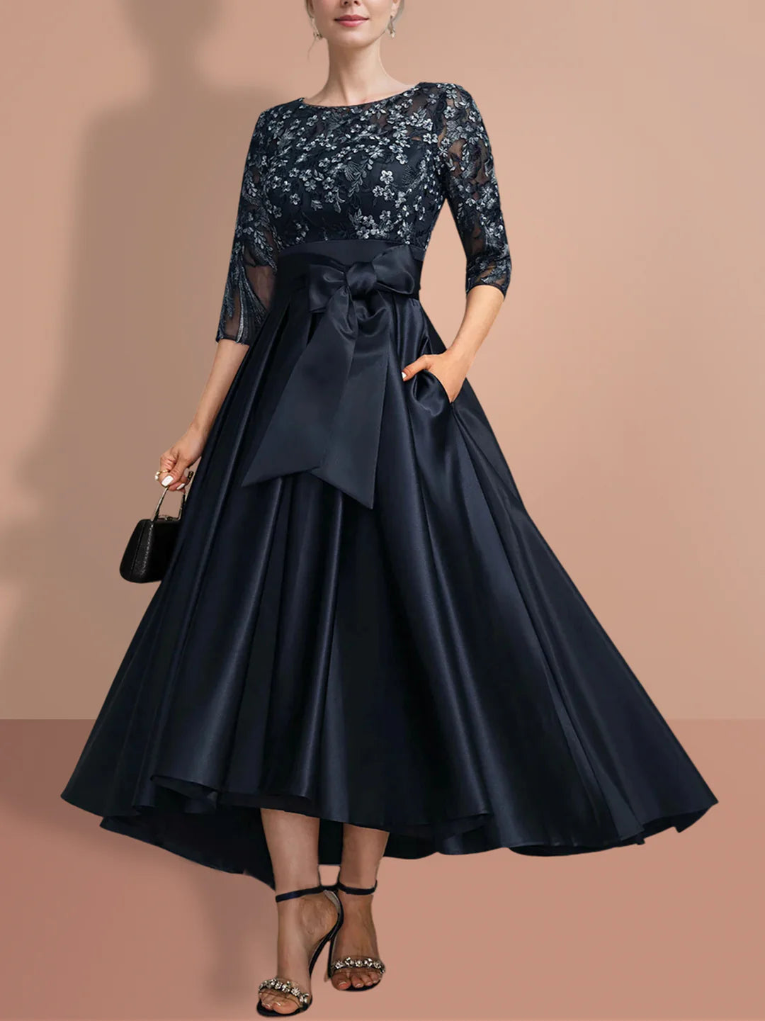 Elegant woman wearing an A-line Mother of the Bride dress with 3/4 sleeves.