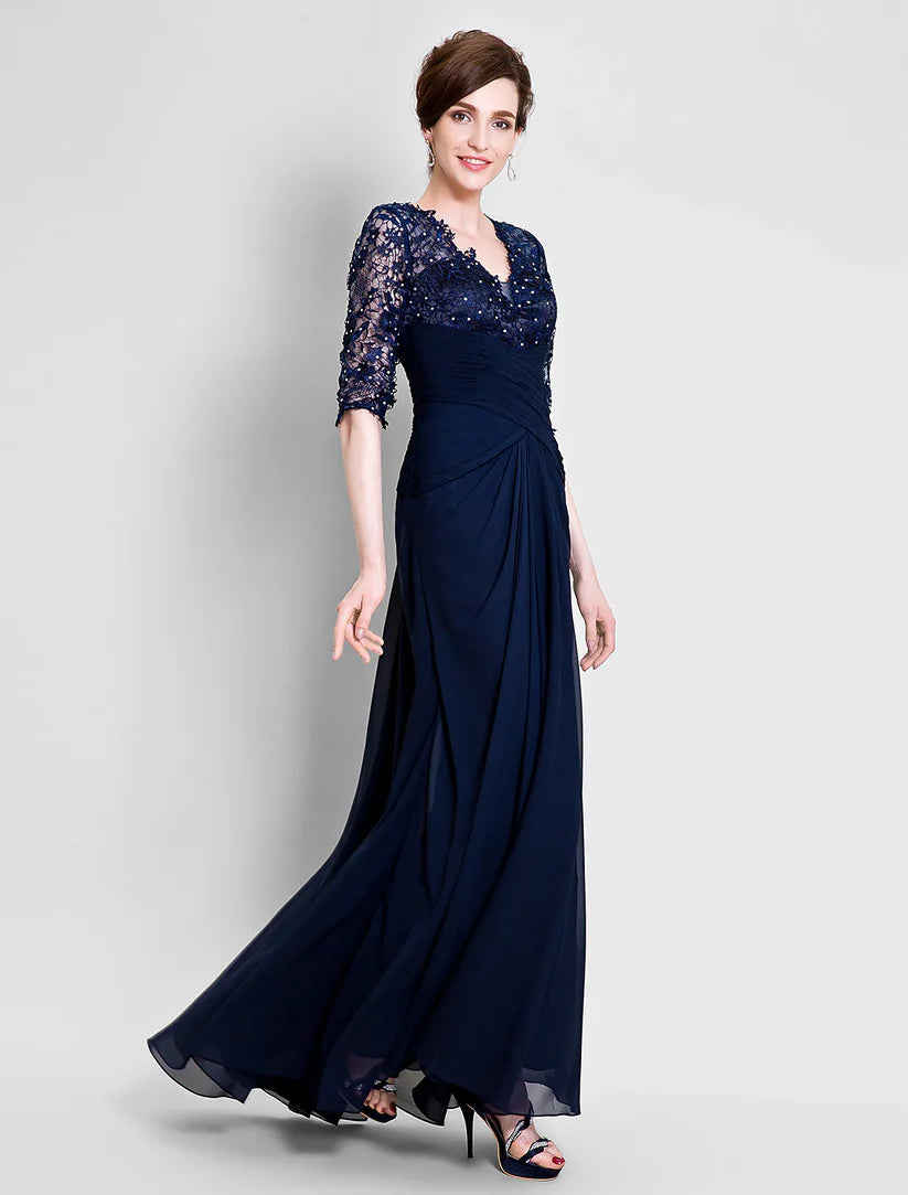 Close-up of the V-neckline and delicate lace and beading on the half sleeves of the dress.