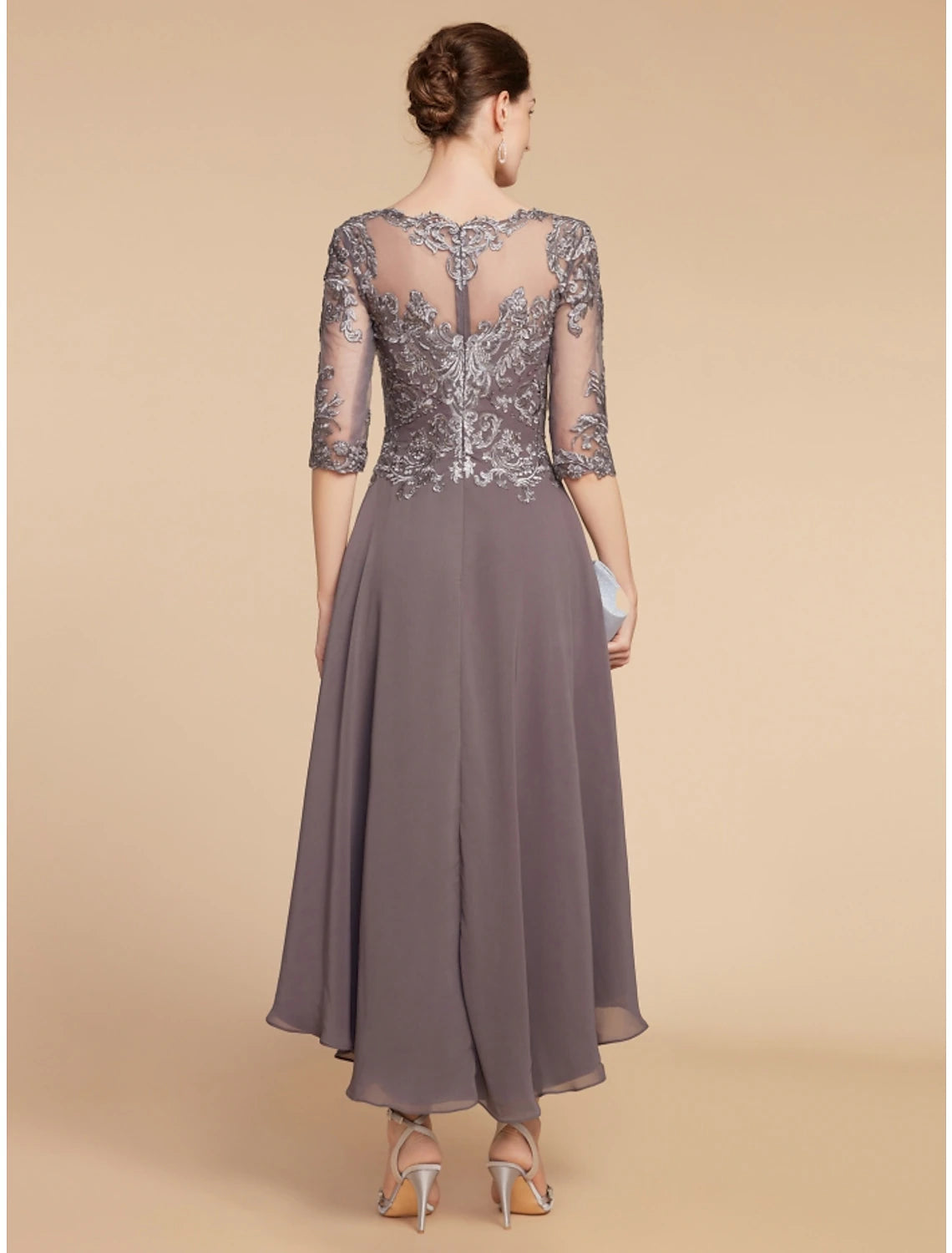 Back view of the A-line chiffon and lace dress with ruching details.