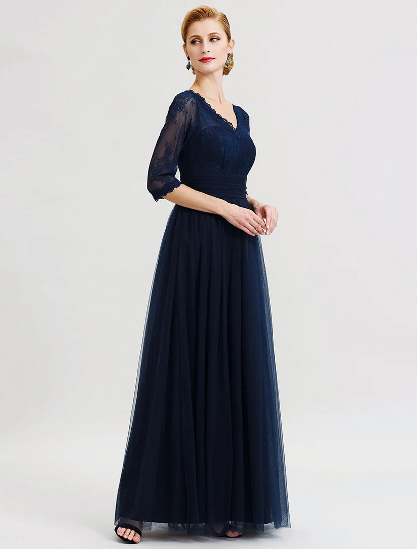 Close-up of the V-neckline and 3/4 sheer lace sleeves on the formal gown.