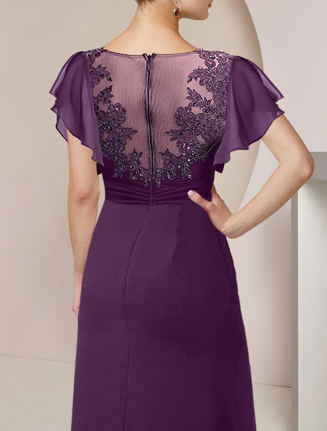 Close-up of the lace, beading, and sequin appliques on the dress sleeve.