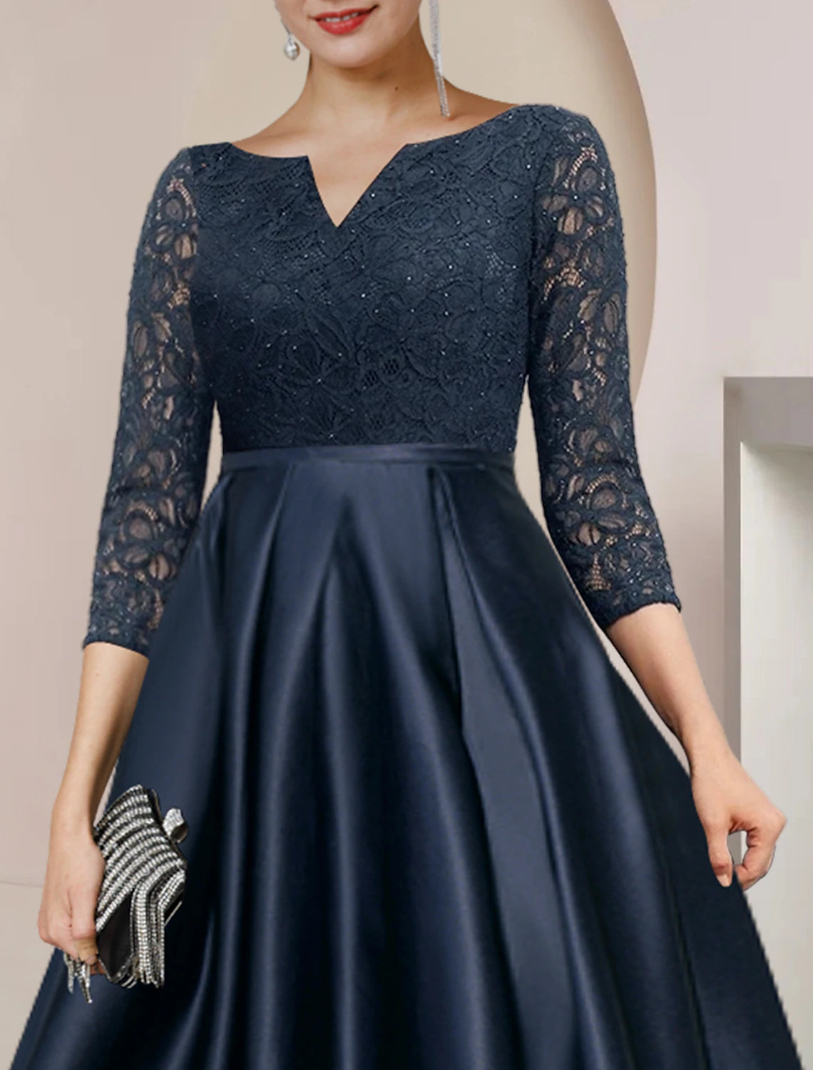 Back view of A-Line Mother of the Bride dress with delicate lace and pleats.