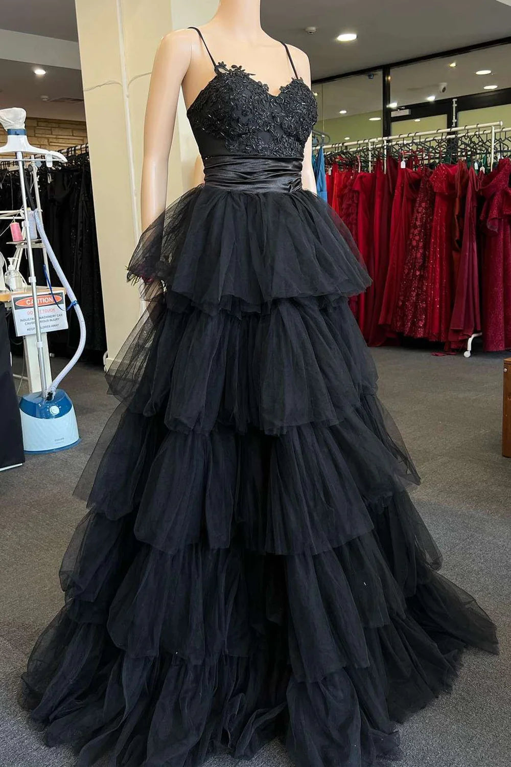 Full view of A-line multi-tiered straps long formal gown.