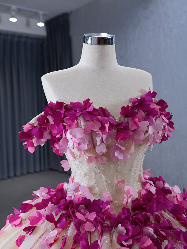 Close-up of the intricate 3D floral appliques and delicate beading on the champagne prom dress.