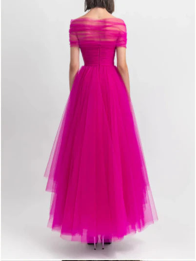 Close-up of an elegant A-line off-shoulder evening dress on a woman.