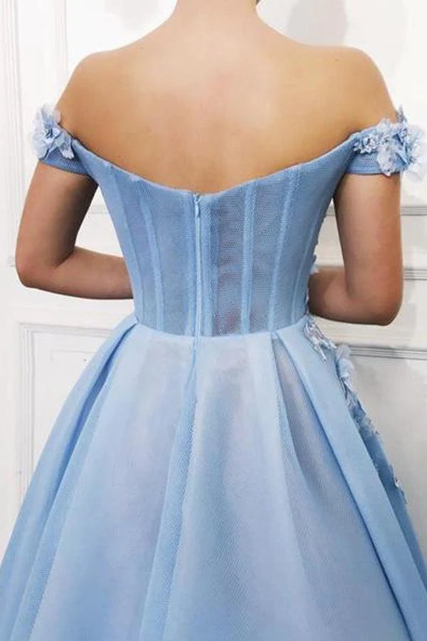 Close-up of floral appliques on an off-shoulder prom dress.