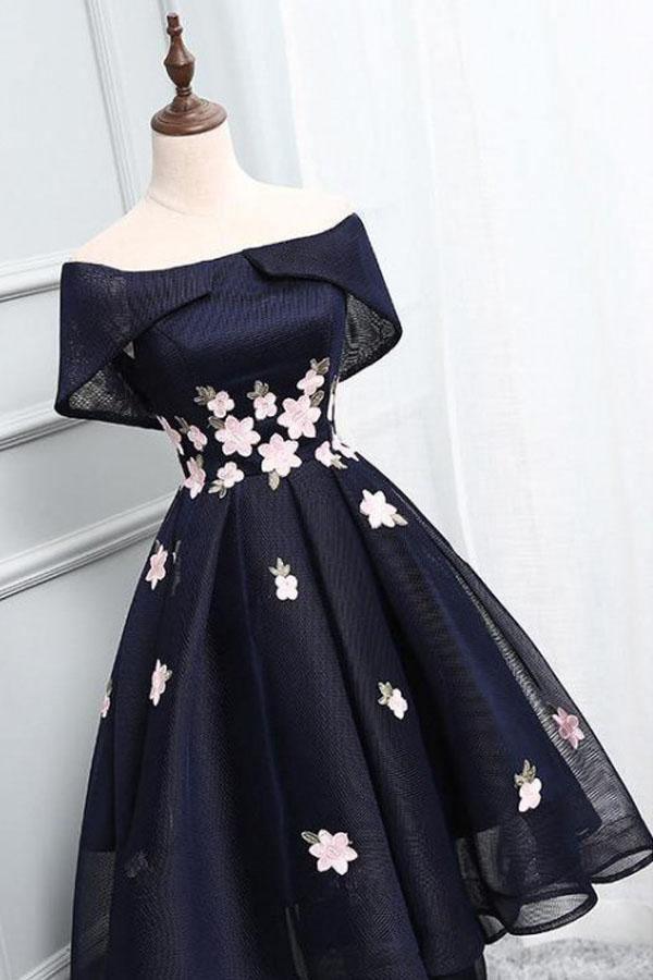 Woman wearing an off-shoulder A-line high-low homecoming dress with appliques.